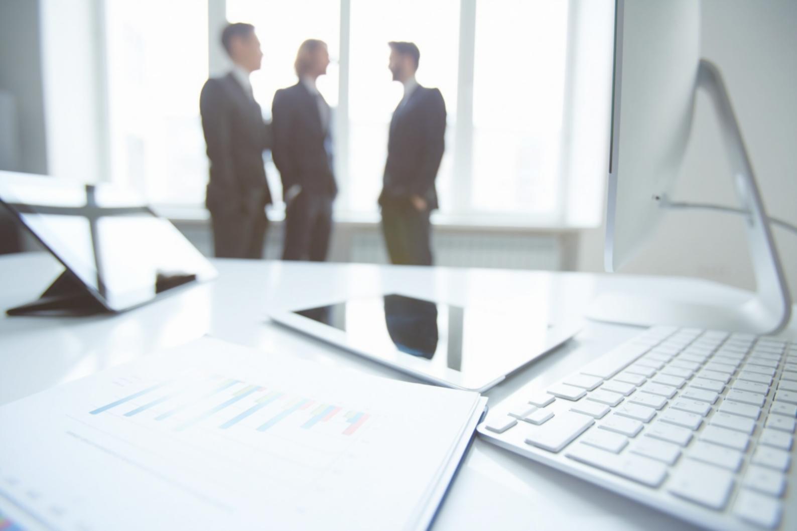 Professional financial analysis workspace with documents and calculator